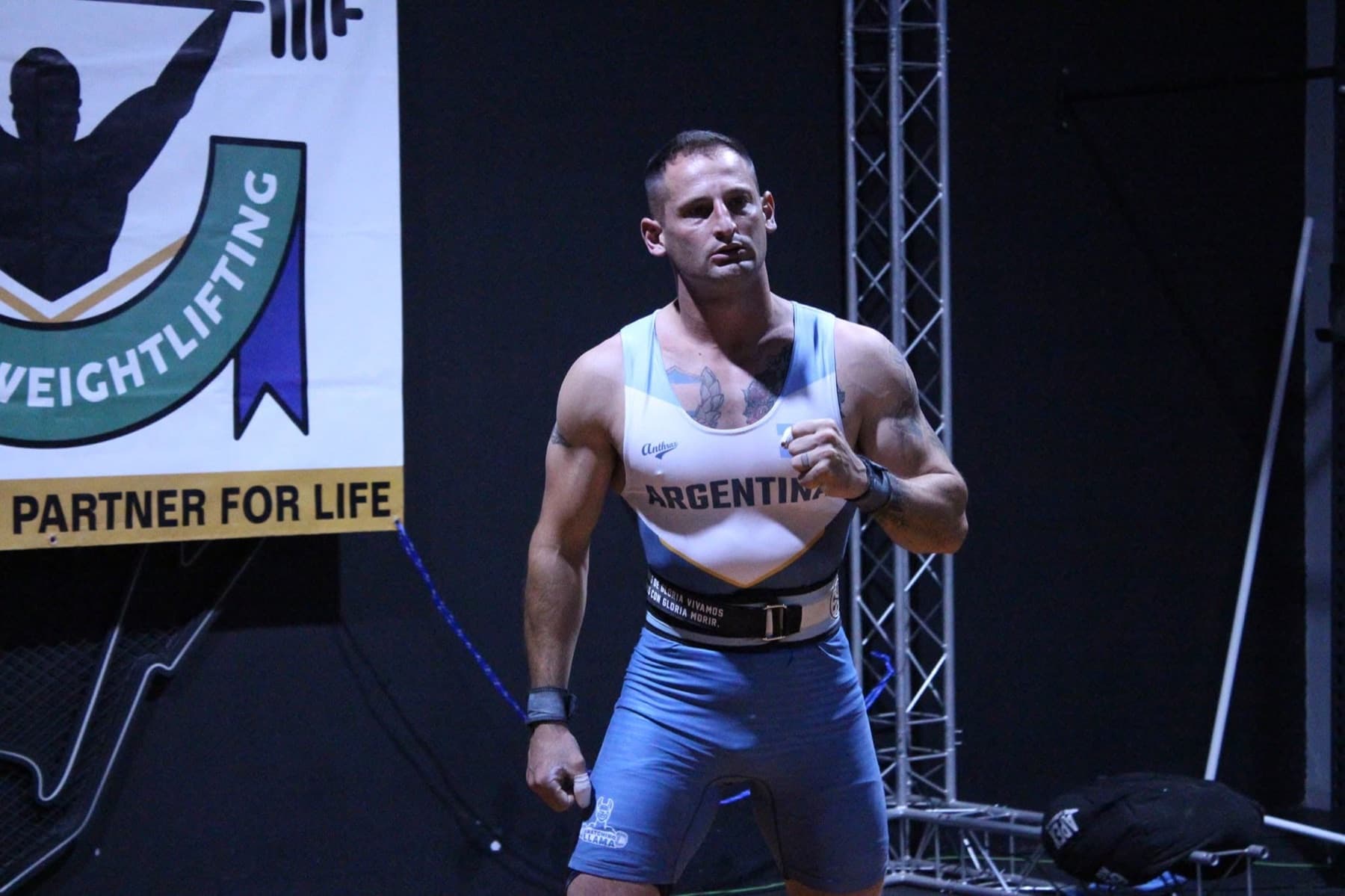 Nick Gindre competing in an Argentina weightlifting singlet at an international meet